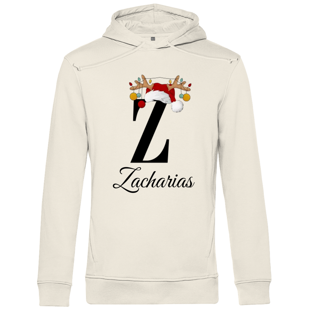 Ein cremefarbener Hoodie mit einem weihnachtlichen „Z“-Design in Schwarz, verziert mit einem Weihnachtsmann-Hut und Rentiergeweihen, an denen bunte Kugeln hängen. Unter dem Buchstaben steht der Name „Zacharias“ in eleganter, geschwungener Schrift. Der Hoodie strahlt eine festliche und personalisierte Stimmung aus, perfekt für die Weihnachtszeit.