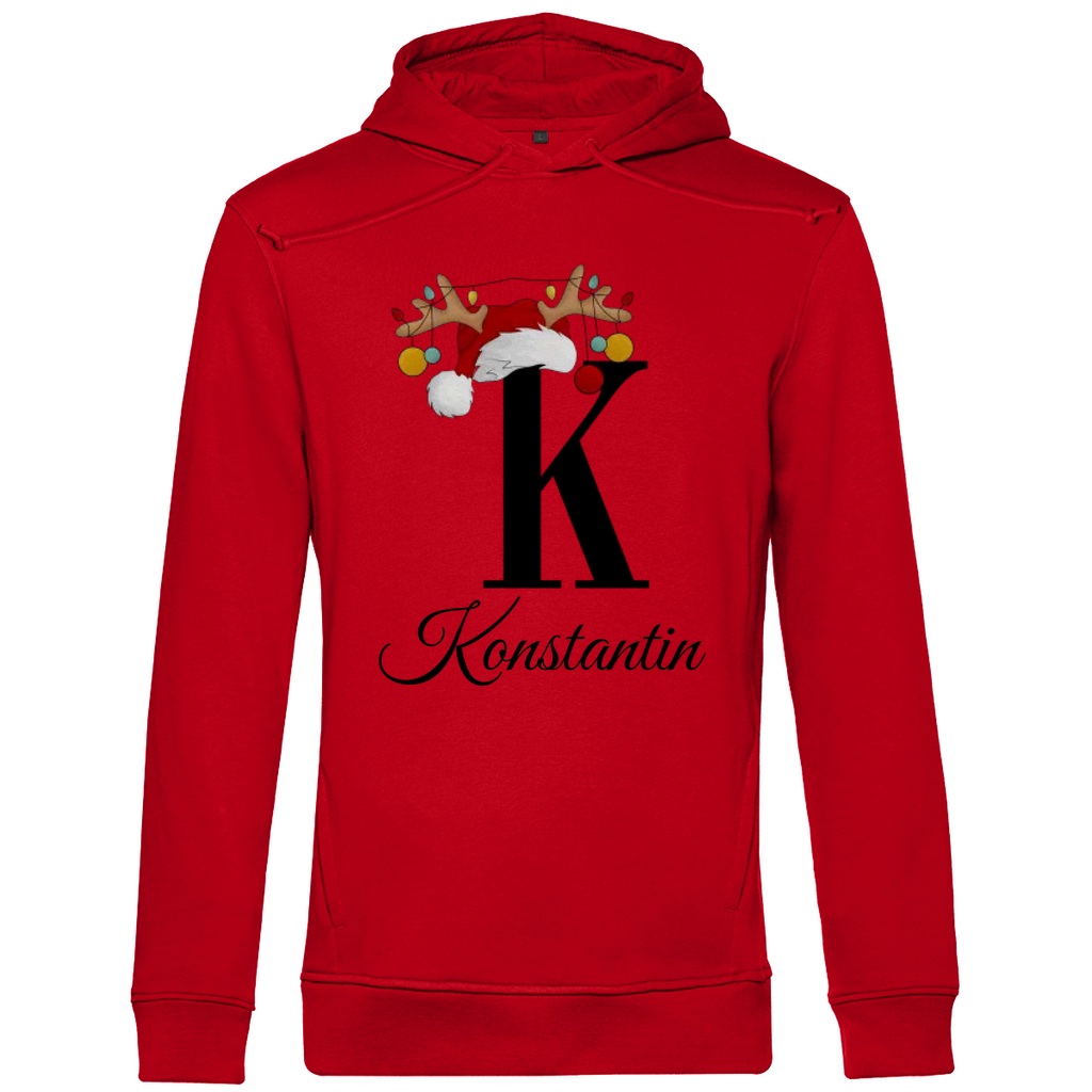 Ein roter Hoodie mit einem weihnachtlichen Design, das den Buchstaben "K" zeigt. Der Buchstabe ist in schwarz gehalten und mit einem Weihnachtsmann-Hut sowie Rentiergeweihen verziert, an denen bunte Kugeln hängen. Unter dem Buchstaben ist der personalisierte Name "Konstantin" in eleganter, geschwungener Schrift zu sehen. Der Hoodie strahlt eine festliche und personalisierte Stimmung aus und eignet sich perfekt für die Winter- und Weihnachtszeit.