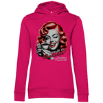 Pinker Damen-Hoodie mit einem Vintage-inspirierten Design. Das Motiv zeigt eine Frau mit roten Locken, die lächelnd eine Kaffeetasse hält und dabei zwinkert. Der Text lautet „None of my Business!“, gefolgt von „Your drama is really entertaining to someone else.“. Der Hoodie kombiniert ein humorvolles, retro-ästhetisches Motiv mit lebendigen Farben.